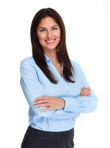 Confident executive professional with long brown hair in a blue shirt, smiling with arms crossed.